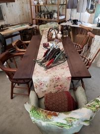 Large vintage wood farm table, various chairs, floral table runner, and various dishes.