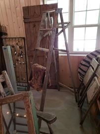 Vintage wood ladder, barn door, baby bed springs, and metal folding chairs.