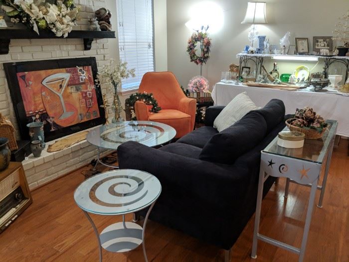 Dark navy blue microfiber love seat and orange chair. Silver glass top tables with a great design.