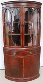 Bow glass corner cabinet by Fancher