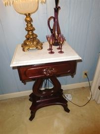 One of two marble top end tables