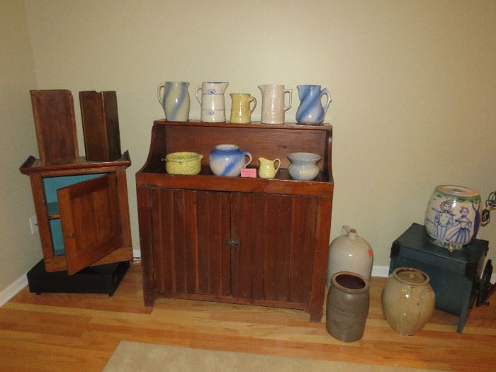A Primitive Dry sink loaded with crocks and stoneware