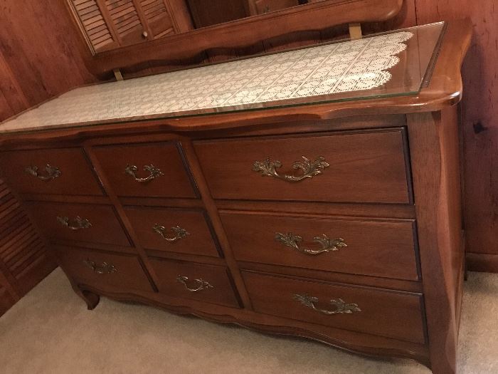 a French Provincial style dresser with mirror. Classic. Well made. Great hardware.