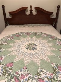 Broken arch and finial bed with mattresses and a gorgeous quilt style spread