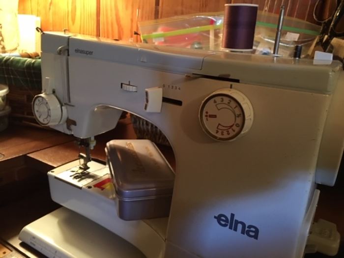 Elna sewing machine.  Includes cabinet.