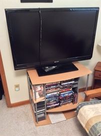 Flatscreen TV, TV Stand and DVDs. 