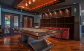 Custom made pool table ‘’ The Vibe” brushed stainless steel and walnut, billiard felt: Titanium – matching vibe cue rack - 109’’ L x 63’’ W x 32’’ H. Montpasnasse Sconces - two available - Chrome with marbled glass shade. Custom made banquette back fully upholstered in brown mohair can be used as headboard - 137’’ L x 69’’ H. Custom made banquette seating fully upholstered base and seat with five cushions - 112’’ L x 22’’ D x 32’’ H.
