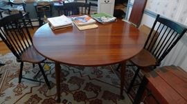 Cherry dining room table. 48" diameter plus a 10" leaf and a protective pad that will cover entire table with or without leaf.