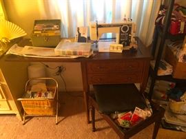 vintage sewing machine in cabinet