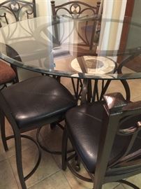 Glass high pub table with four upholstered chairs 