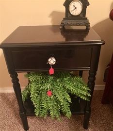 Small end table with clock and fern. 