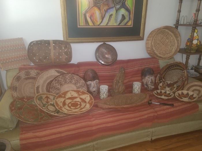 Baskets, wooden masks, large leaf pottery bowl (sofa not for sale)