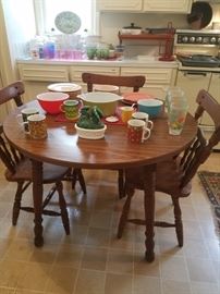 Wooden kitchen table, 3 chairs, Pyrex, Fire King, & other vintage kitchen. 