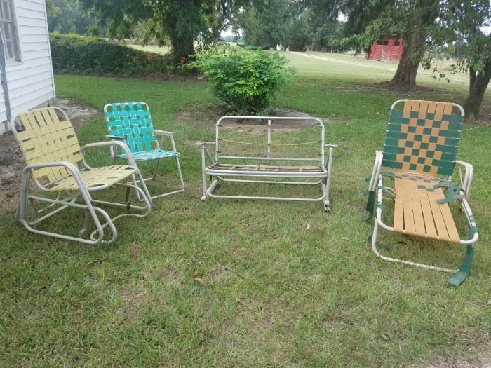 Vintage aluminum yard/patio furniture including chairs, single glider, double glider, lounge chair. 
