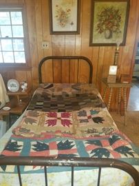 Iron twin bed, original art, end tables. 