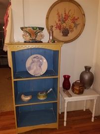Antique framed art, small table, wooden painted bookshelf, and more. 