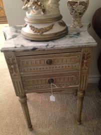 One of two marble top end tables