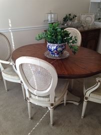 This table has a leaf and 2 more chairs.