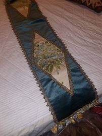 One of two satin embroider runners