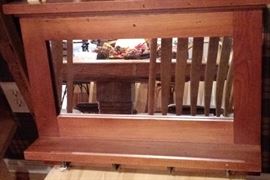 Wood shelf with framed mirror and hooks