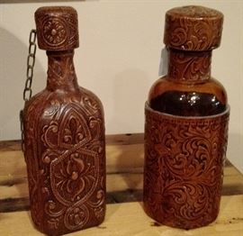 Glass liquor decanters wrapped in tooled leather