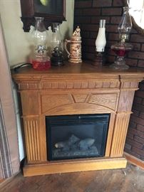 Electric fireplace. Also note oil lamps.