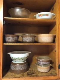 Vintage Pyrex mixing bowls and casseroles. White on top shelf is Fire King