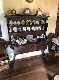 A very unusual and unique display cabinet. Almost reminds me of a Dutch antique. Has center drawers. Lots of china bits.