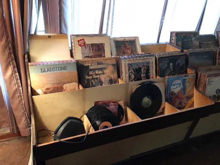 Vinyl LP Records, some 45s. 2 different vintage 1950s tiered store display cabinets with storage underneath. Approximately 20 photos of albums taken at random
