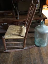 Small rocker and giant glass bottle