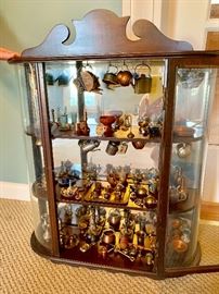 Case full of miniature tea pots and other miniature pieces