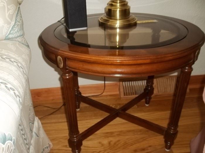 pair of oval glass top and wood end tables