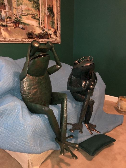 Metal frog sculptures 1) with binoculars 2) reading a book 