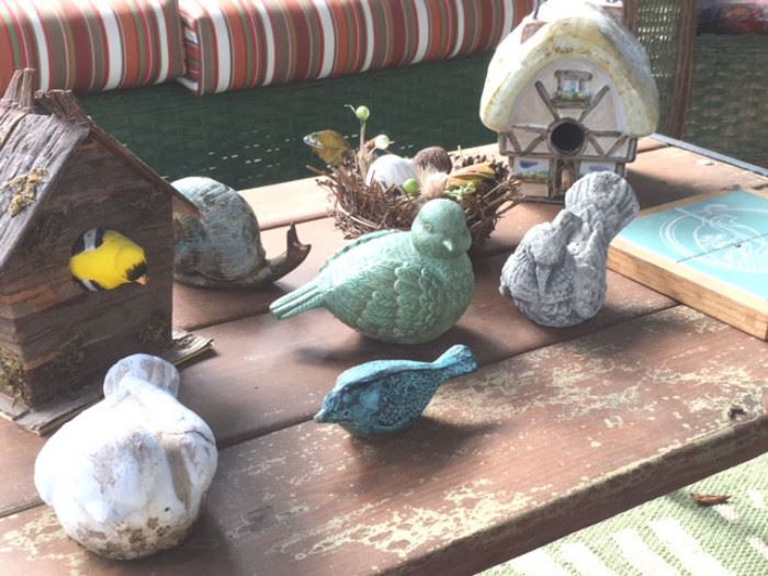 Various whimsical bird and snail sculptures in metal and pottery, also decor bird houses