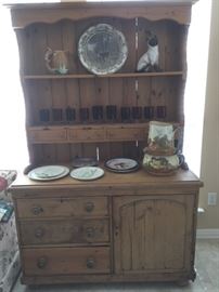Antique pine hutch with multiple drawers and shelves.