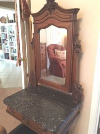 Detail of antique vanity with mirror in French Provincial style, and Italian marble top.