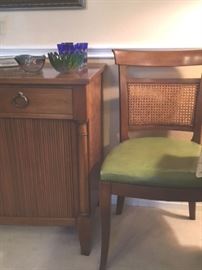 One of six caned back chairs that match a dining room table with 2 leaf extensions. Other is vintage sideboard with drawers and tambour doors by Kindel of Grand Rapids.