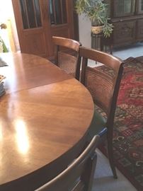 Dining table with 6 matching side chairs and 2 leaf inserts, all by Kindel of Grand Rapids.