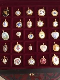 A boxed collection of pendants from around the globe; will sell as one lot