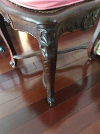 Closeup, cabriole leg of 18th c. French carved wood chairs, set of 8 plus two half chairs.