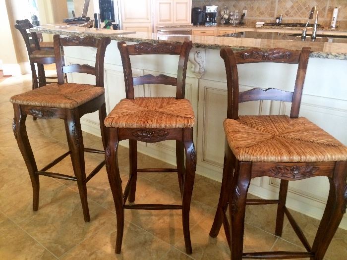There are 5 rush seat barstools
