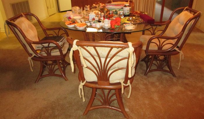 Rattan glass top dining table and four chairs. 