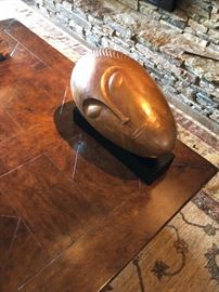brass face on wooden base/stand