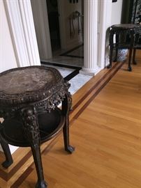 A Pair of Antique Chinese Wood Carved Tables with Marble Tops: Height 32 x Diameter 22 inches. In very good condition.