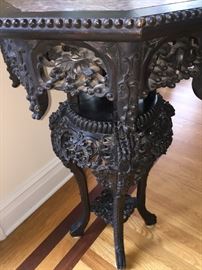 A Chinese Antique Eight-Sided Marble Top Carved Wood Table: Height 34 x Diameter 20 inches. In very good condition.