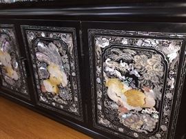 A Pair of Black Laquered with Inlaid Mother-of-Pearl Rectangular Asian Chests: Four doors and four drawers. Height 18 x Width 40 x Depth 14.5 inches. In excellent condition.