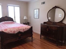 An Antique French Wood Bedroom Suite with Bed Frame and 2 Dressers with Mirrors. Bed Frame: Height 31 x Width 51 x Length 78 inches. Low dresser: Height 70 inches x Width 39 x Depth 20 inches. High Dresser: Height 74 x Width 52 x Depth 22 inches. In very good condition.