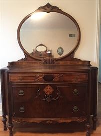 An Antique French Wood Bedroom Suite with Bed Frame and 2 Dressers with Mirrors. Bed Frame: Height 31 x Width 51 x Length 78 inches. Low dresser: Height 70 inches x Width 39 x Depth 20 inches. High Dresser: Height 74 x Width 52 x Depth 22 inches. In very good condition.