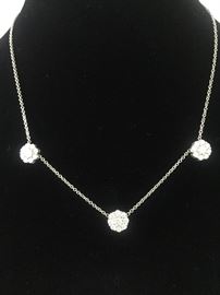 18KT WHITE GOLD AND DIAMOND FLEURETTE 3-FLOWER NECKLACE: In excellent condition. Comes with beautiful original box. Stamped and tested 18KT white gold lady's hand assembled three diamond cluster necklace with a shared prong set, with an 18KT white gold lobster clasp and bright polish finish. Identified with markings of "18kt/750". Appraisal report included. Containing: Total Weight of Diamonds: 1.64 ct. Total Weight of Three Diamond Cluster Necklace: 6.00 gm. Three shared prong set round brilliant cut diamonds exact total weight of 3 stones = 0.52 ct. Clarity: VS. Color: F-G. Cut: Excellent. Twenty-four shared prong set round brilliant cut diamonds exact total weight 24 stones = 1.12ct. Clarity VS. Color: F-G. Cut: Excellent. Free shipping with insurance on this item.