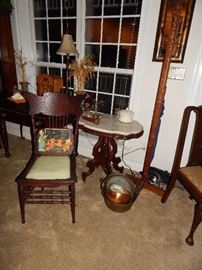 Marble top side table (one of many). Copper pots.